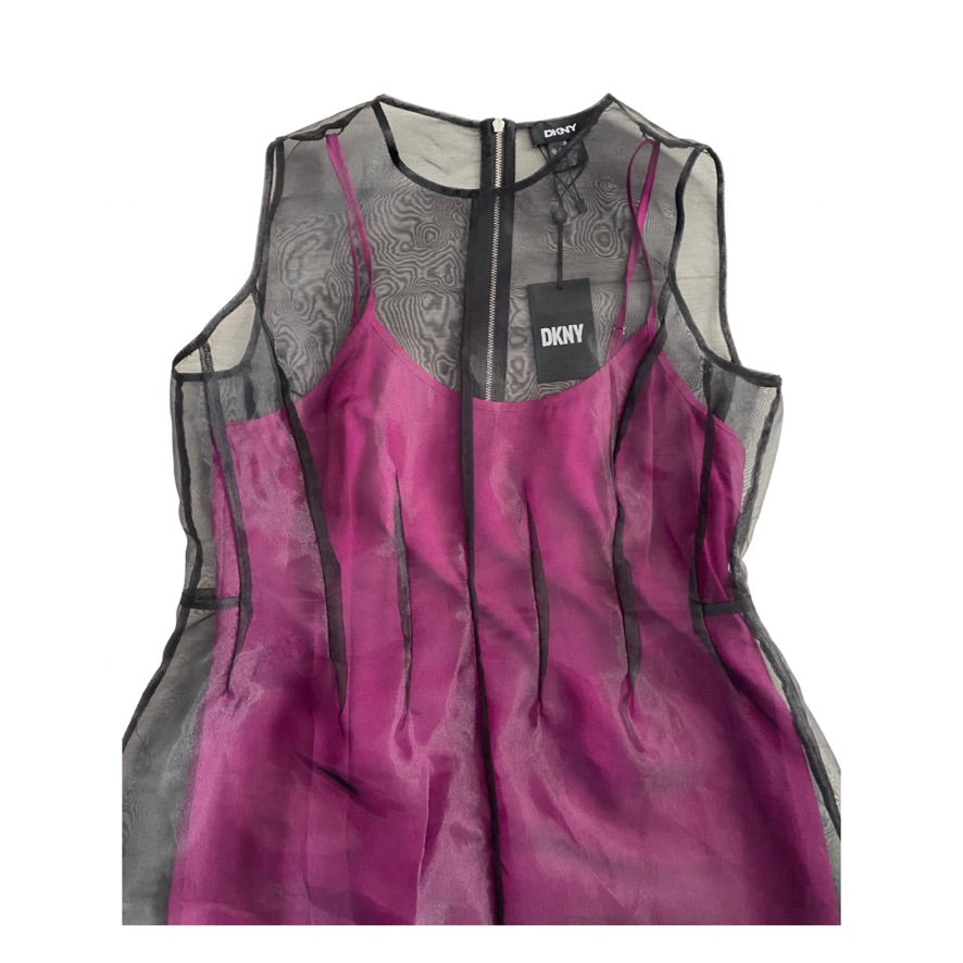 Pink and black dress with DKNY label on a white background