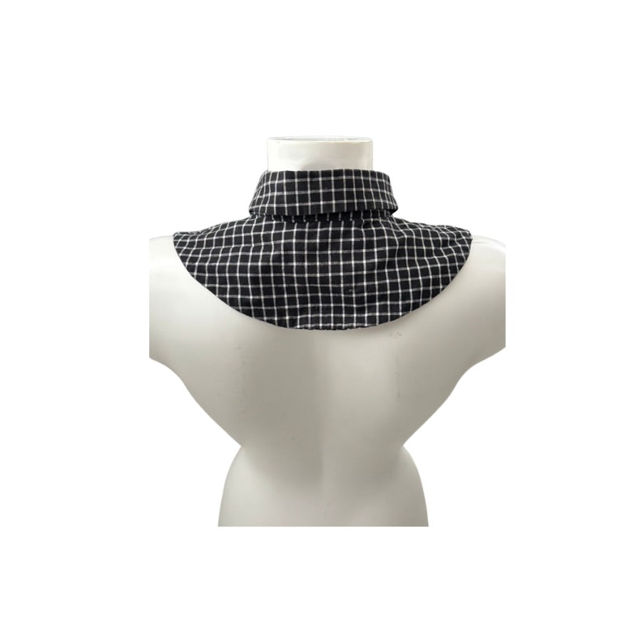 Black and white checkered neckwarmer on a mannequin bust against a white background