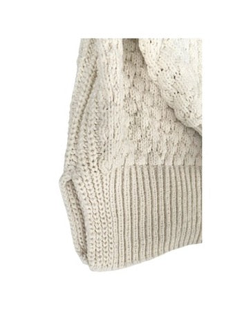 Close-up of a beige knitted sweater on a white background