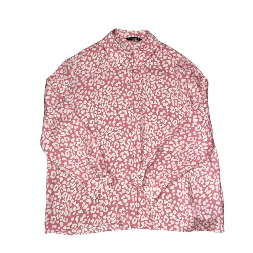 Pink blouse with white floral pattern on a white background