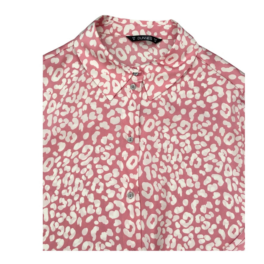 Pink shirt with white leopard print pattern on a white background