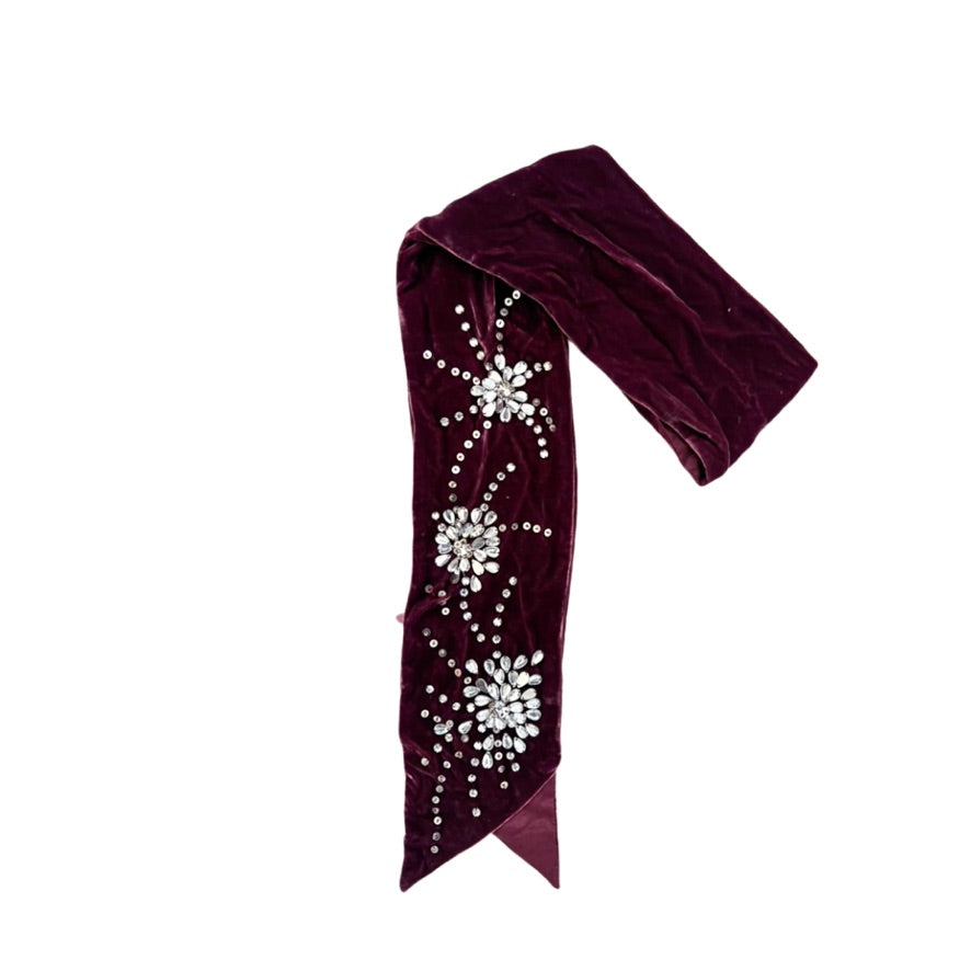 Maroon headband with decorative elements on a white background