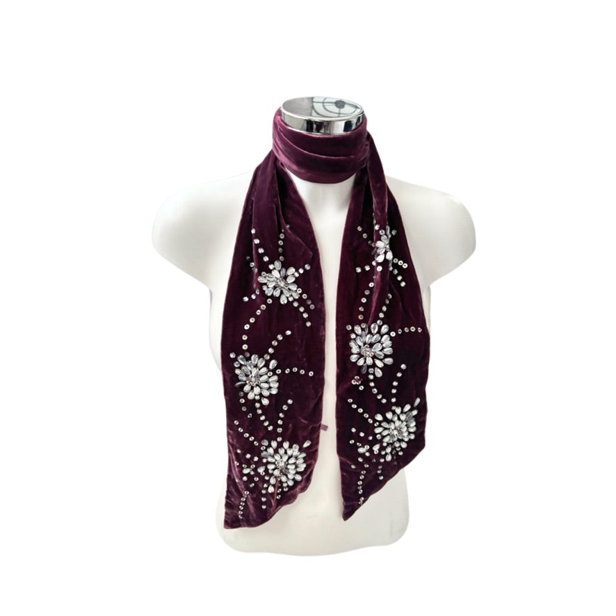 Burgundy scarf with decorative elements on a mannequin against a white background