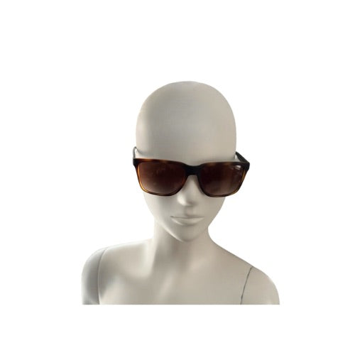 Mannequin head wearing brown sunglasses on a white background