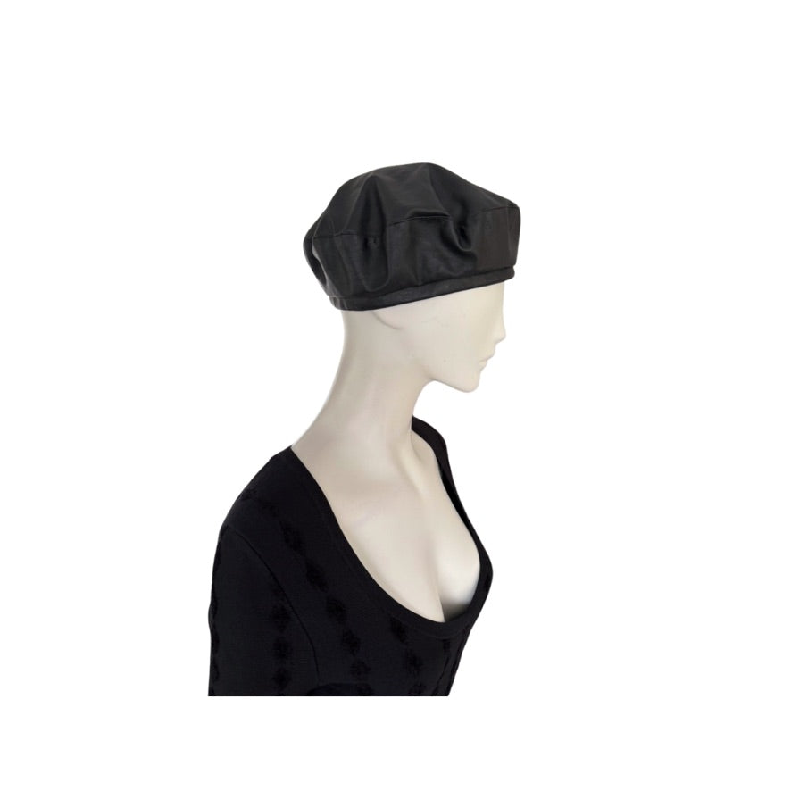 Mannequin head wearing a black beret on a white background