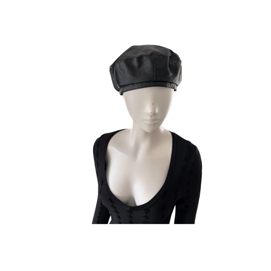 Mannequin head wearing a black beret on a white background