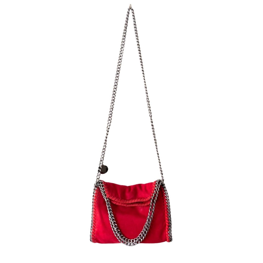 Red handbag with a chain strap on a white background