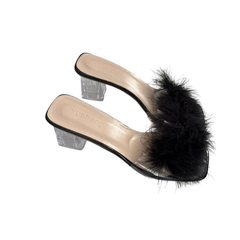 High-heeled shoe with black feather detail on a white background