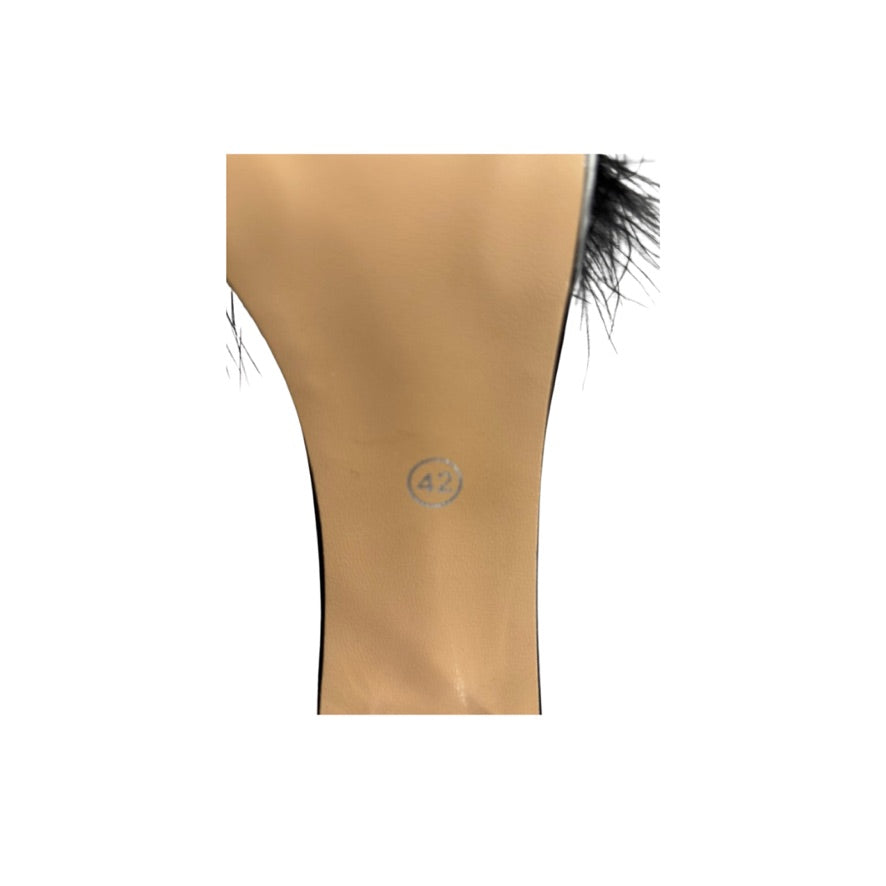 Shoe soles with black feather details on a white background