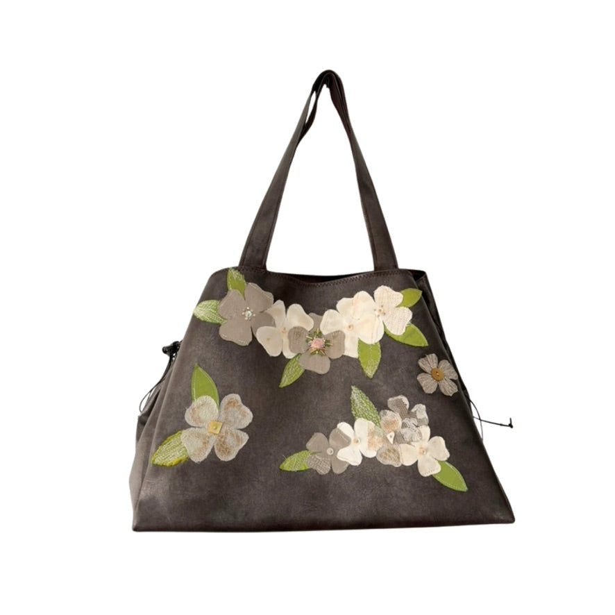 Floral-patterned handbag on a white background
