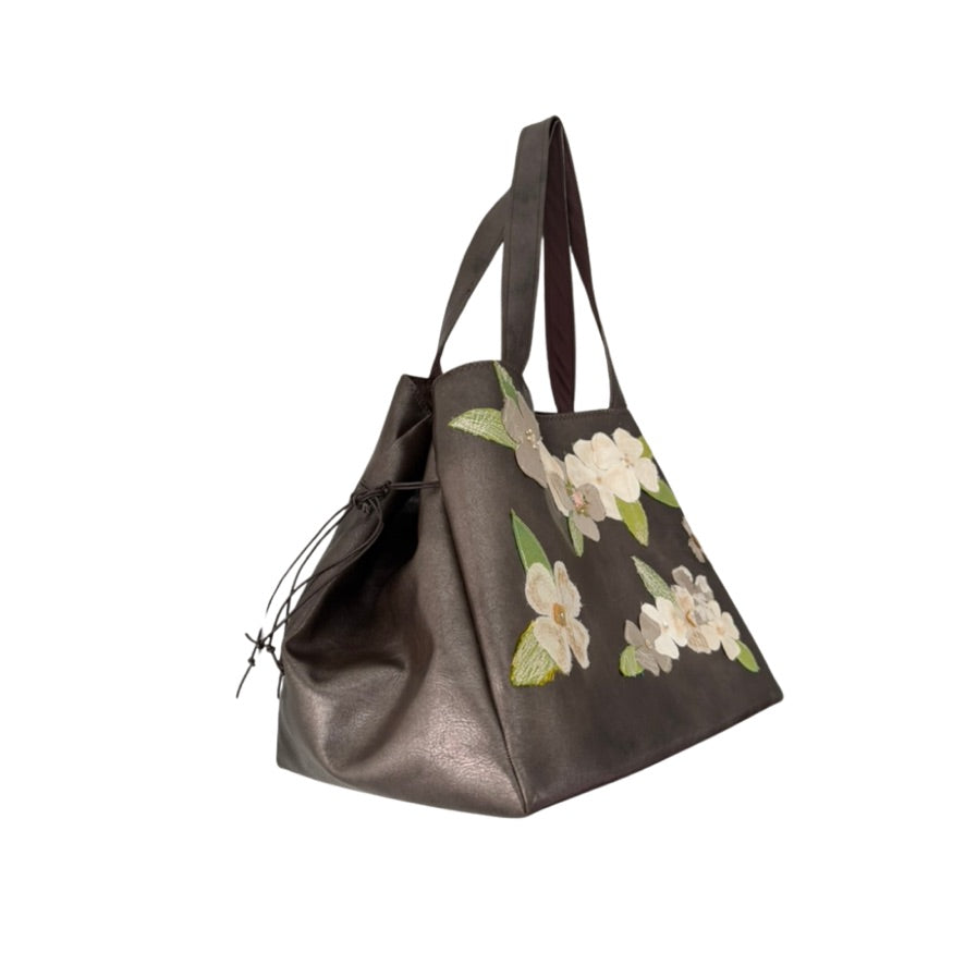 Brown tote bag with floral embroidery on a white background