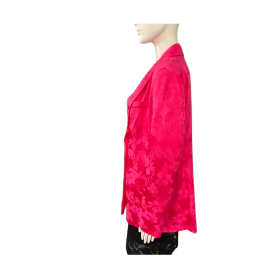 Mannequin wearing a bright pink floral patterned top on a white background