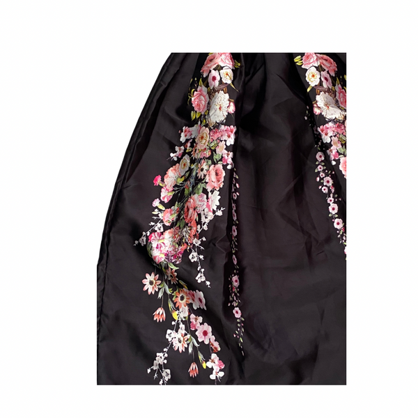 Black skirt with floral embroidery on a white background