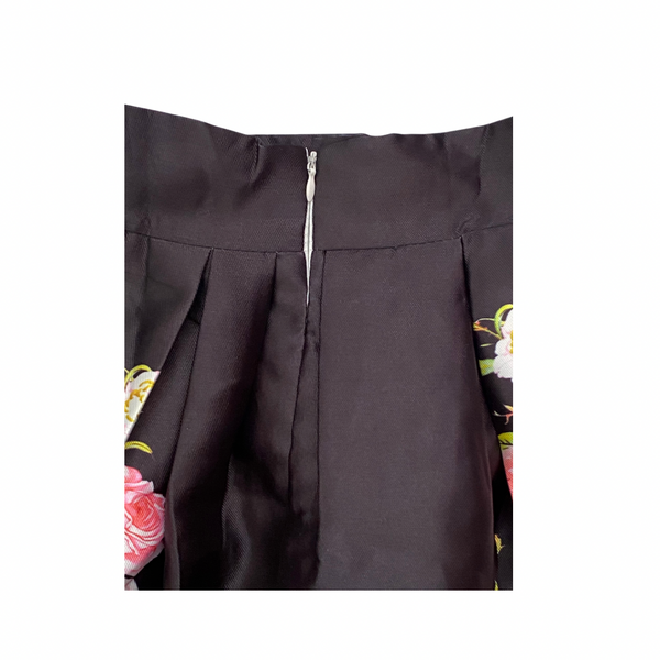 Black garment with floral embroidery on a white background