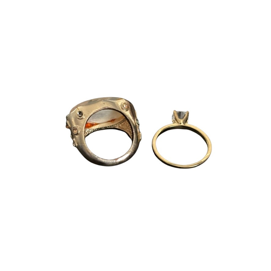Two gold rings on a white background