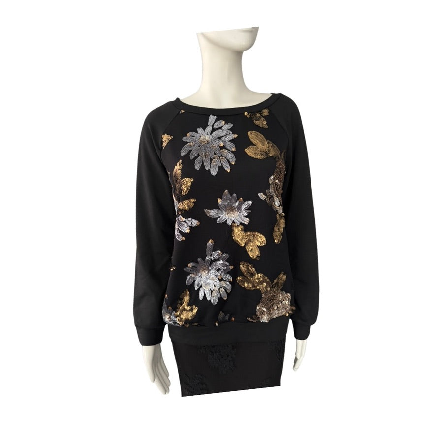 Black sweater with floral sequin patterns on a mannequin against a white background