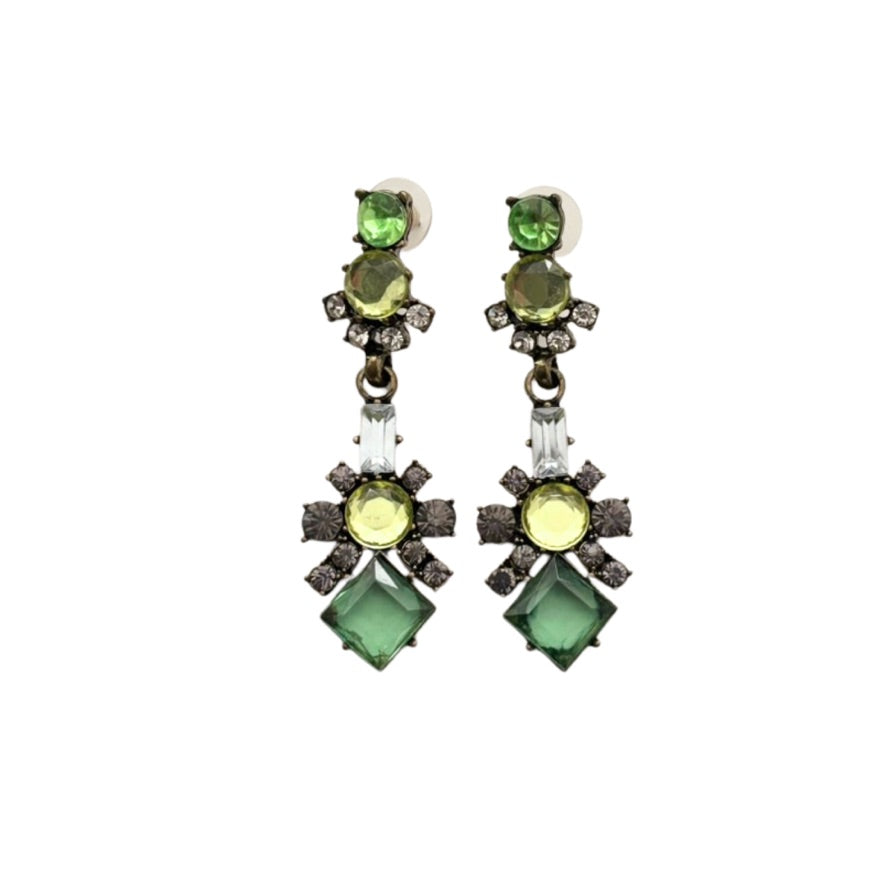 Pair of earrings with green gemstones on a white background