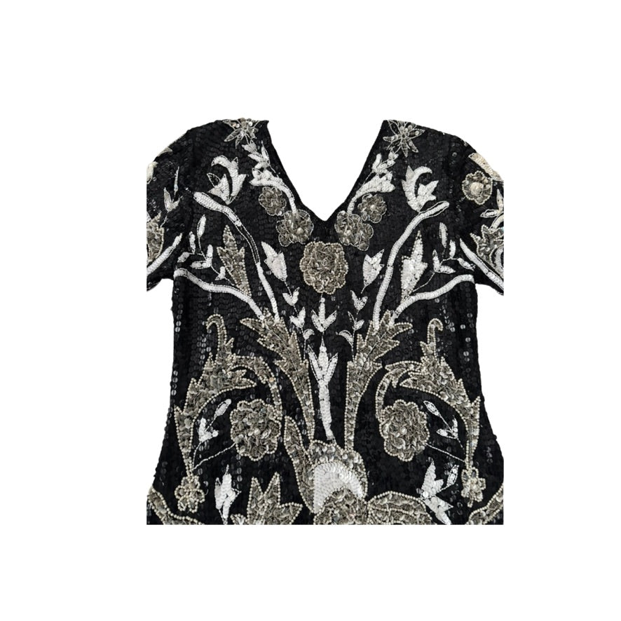 Black top with floral embroidery on a white background