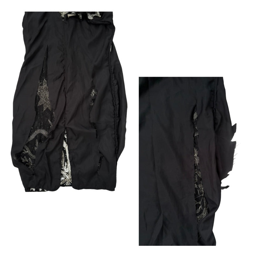 Black garment with intricate detailing on a white background