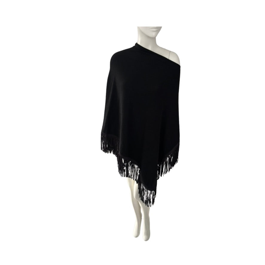 Black poncho with fringe on a mannequin against a white background