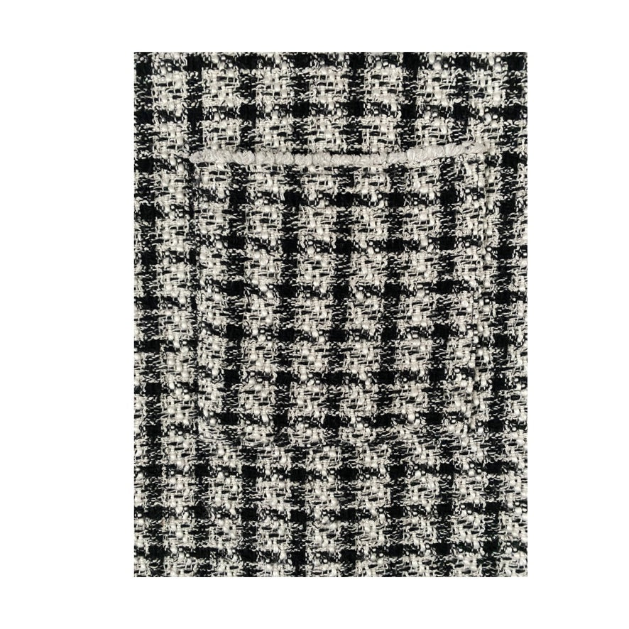 Black and white checkered pattern on a textured surface