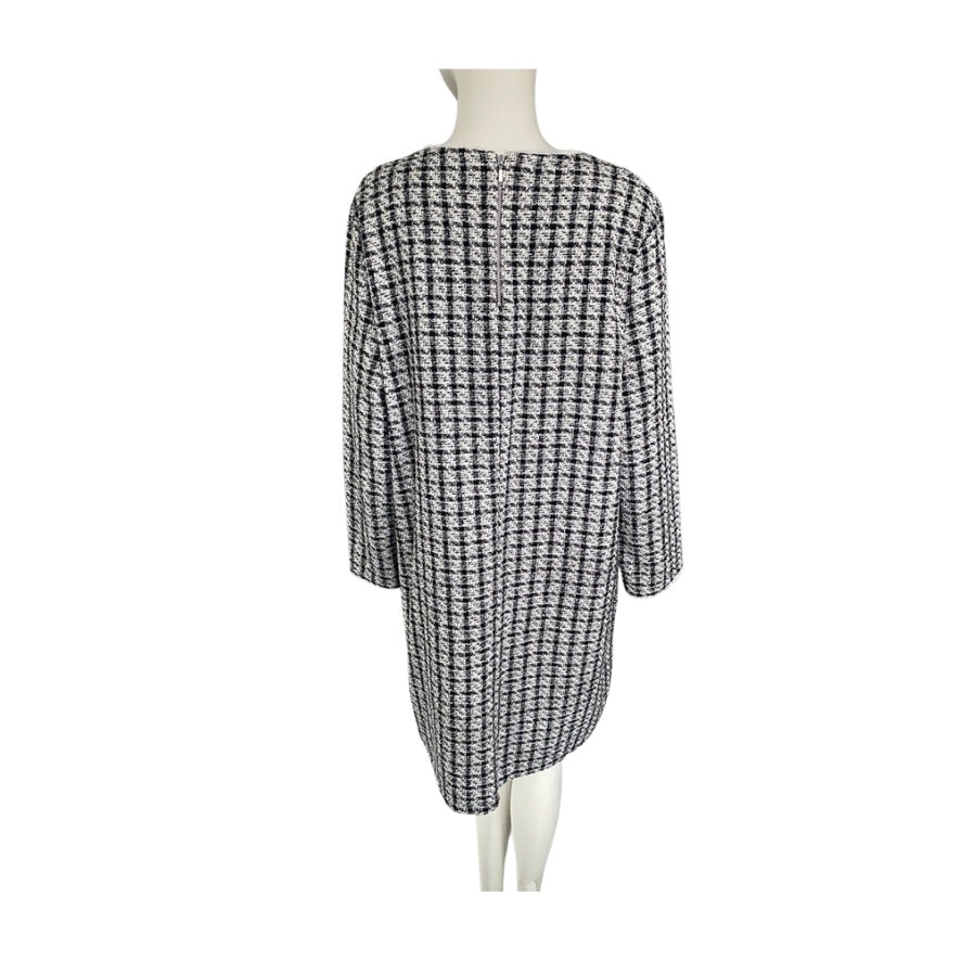 Black and white checkered dress on a mannequin against a white background