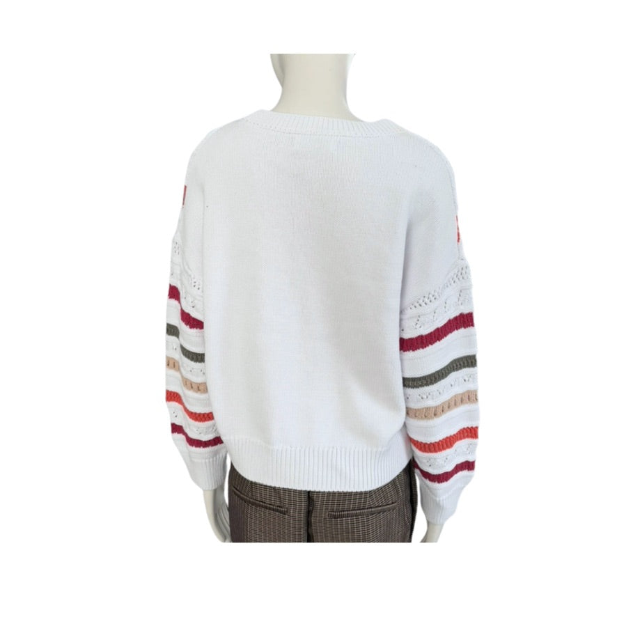 White sweater with colorful striped sleeves on a mannequin against a white background