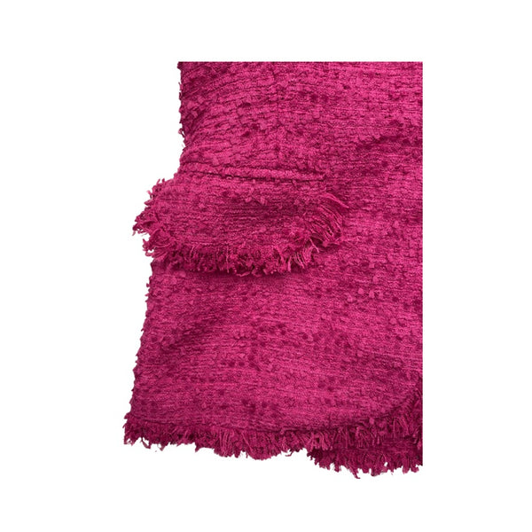 Fuchsia textured rug with frayed edges on a white background