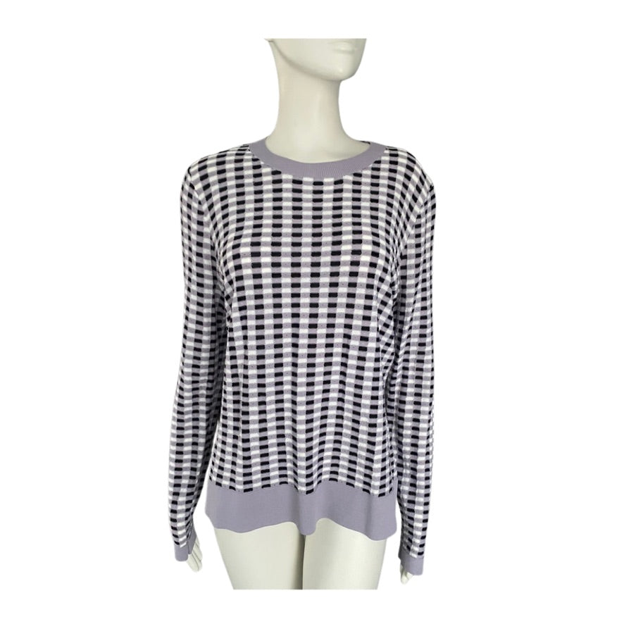 Black and white and lilac checkered sweater on a mannequin against a white background