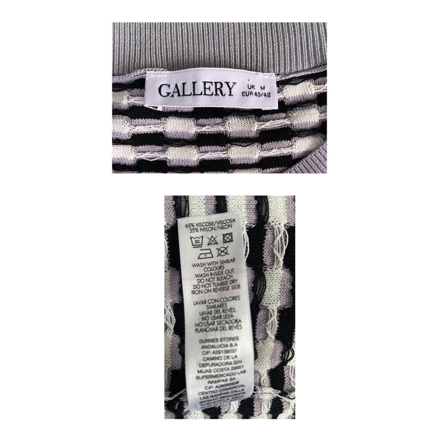Close-up of a patterned garment with 'Gallery' label and care instructions on a white background
