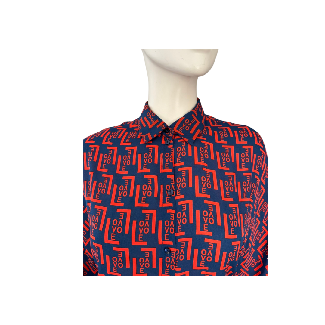 Mannequin wearing a blue shirt with red geometric pattern on a white background