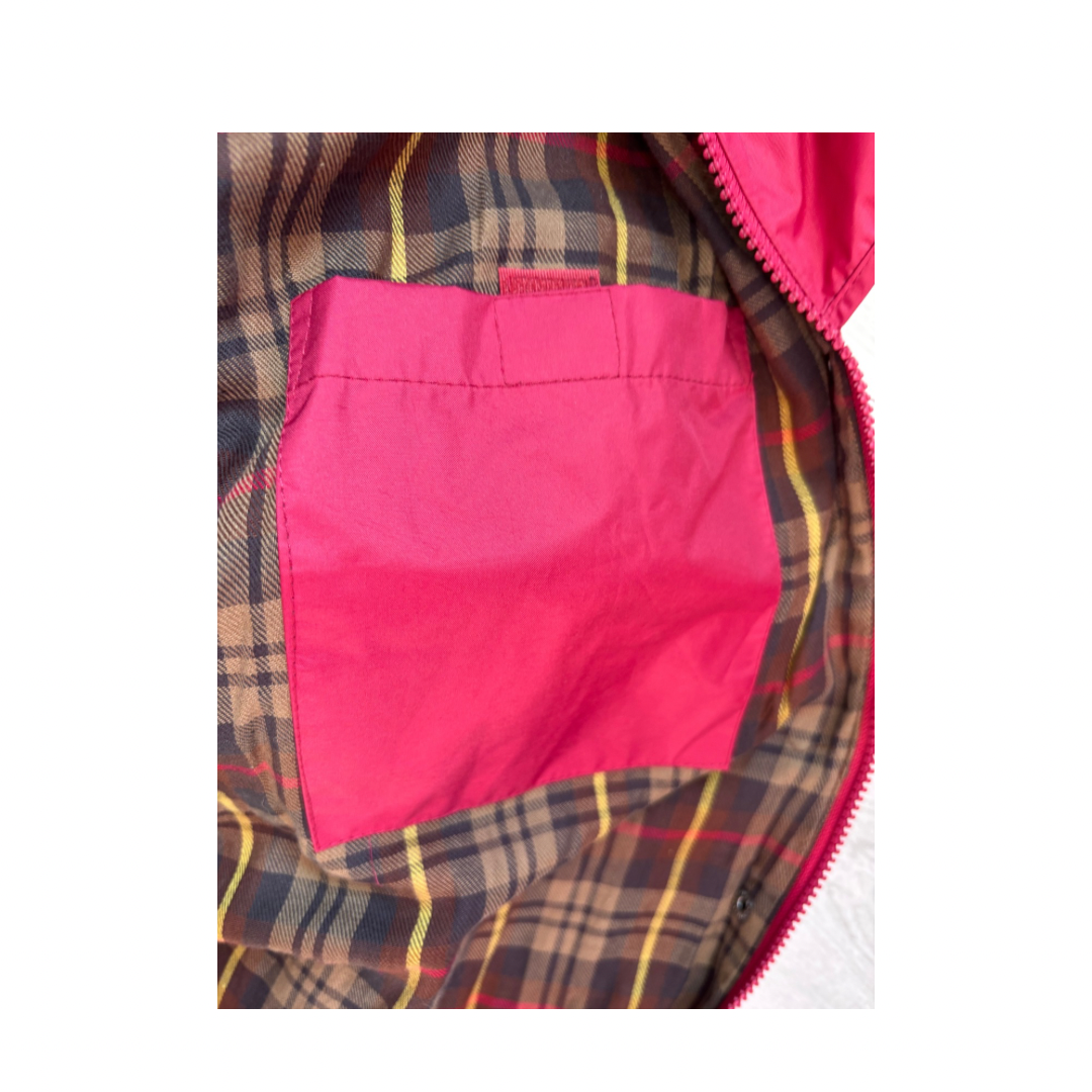 Close-up of a pink pocket on a plaid fabric background