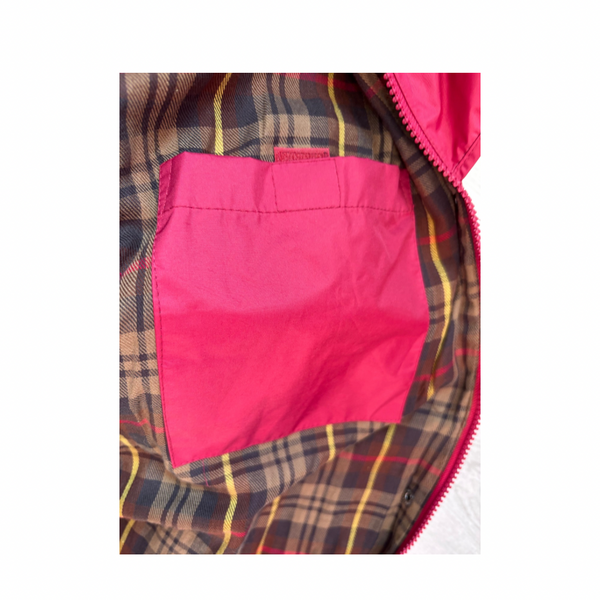 Close-up of a pink pocket on a plaid fabric background