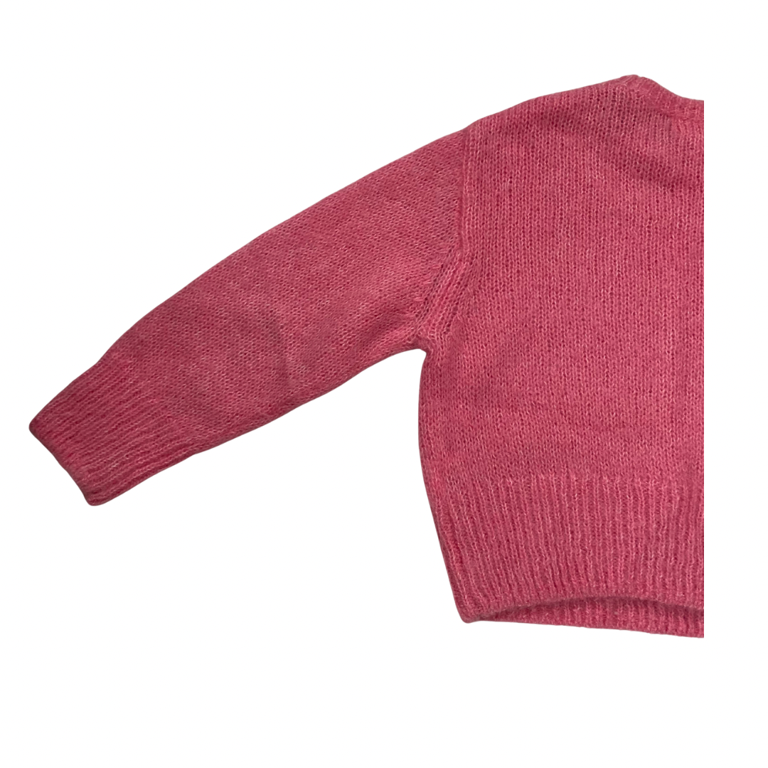 pink knitted sweater on a white background