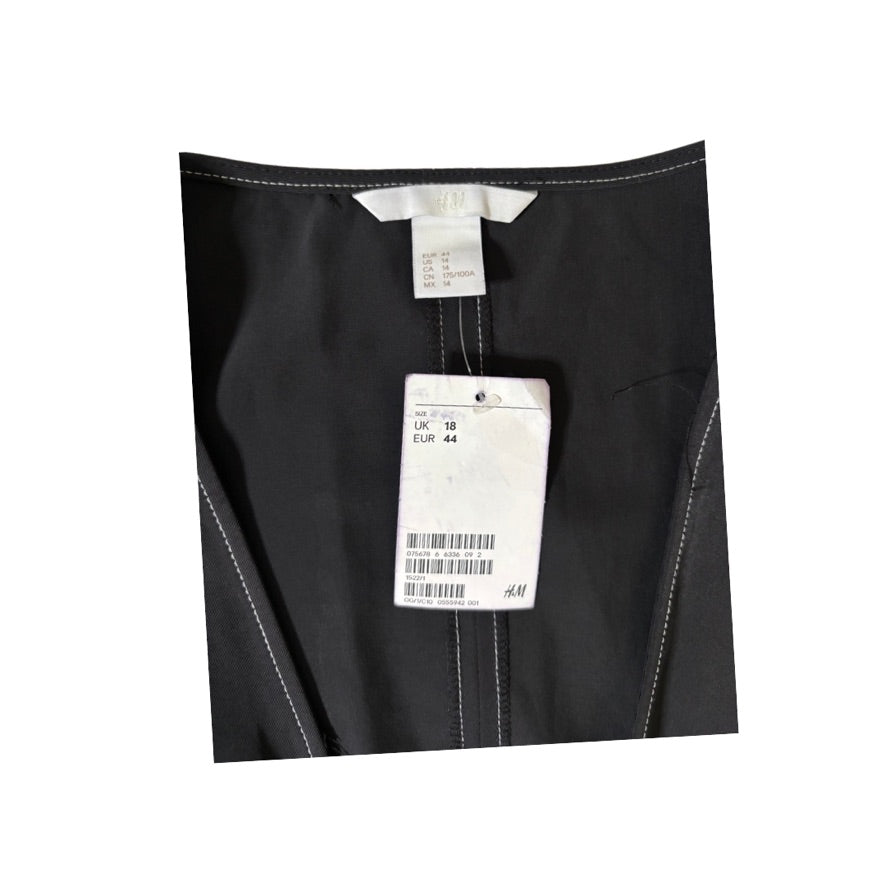 Black pants with a tag on a white background