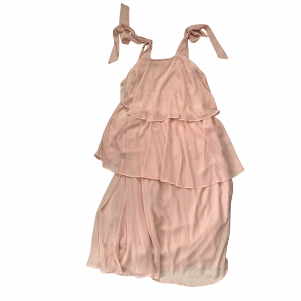 Pink tiered dress with ribbon straps on a white background