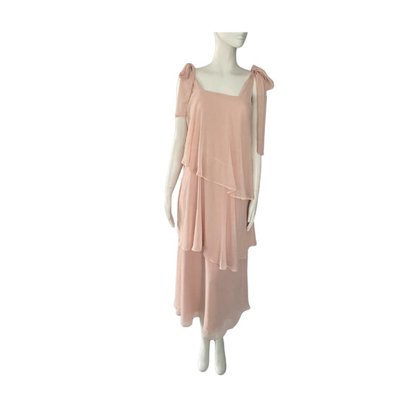 Mannequin wearing a light pink dress on a white background