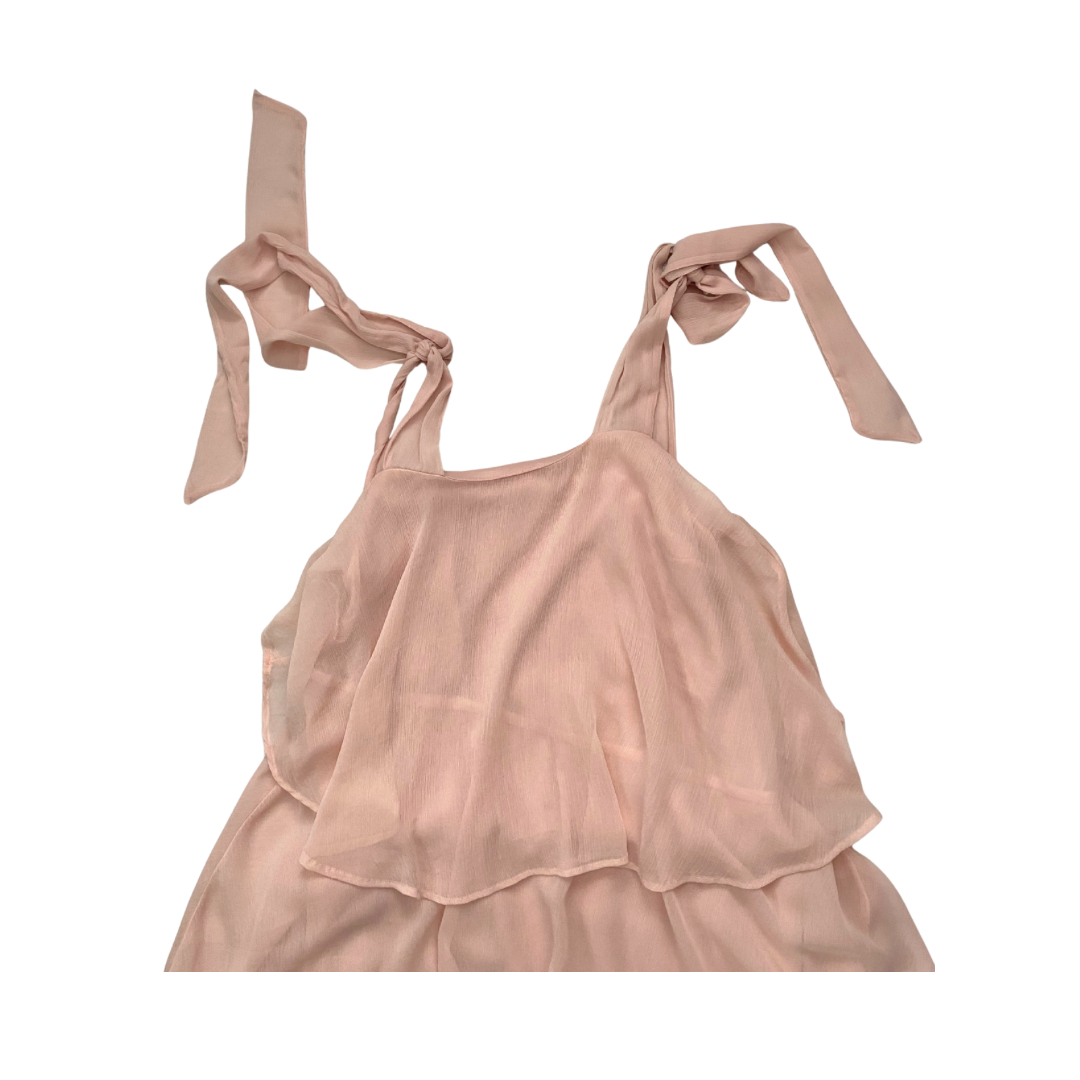 Pink dress with ribbon straps on a white background