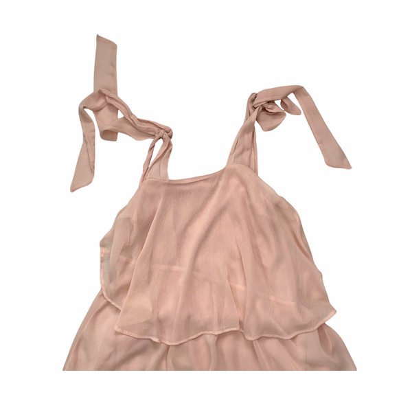 Pink dress with ribbon straps on a white background