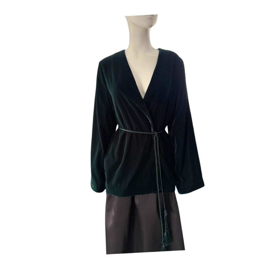 Mannequin wearing a dark green velvet wrap dress with a white background