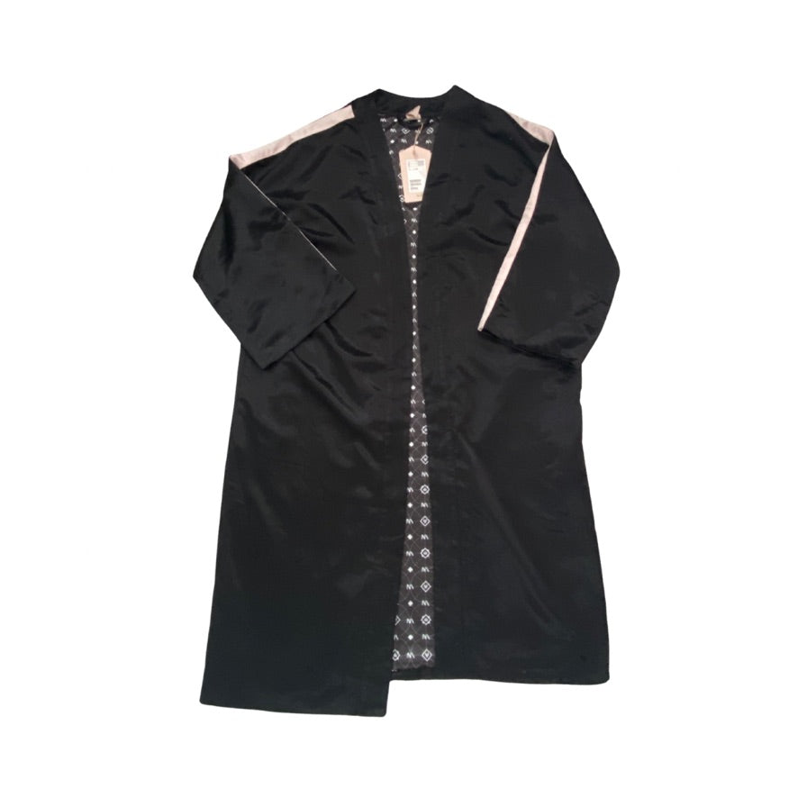 Black dress with intricate white embroidery on a white background