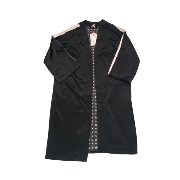 Black dress with intricate white embroidery on a white background