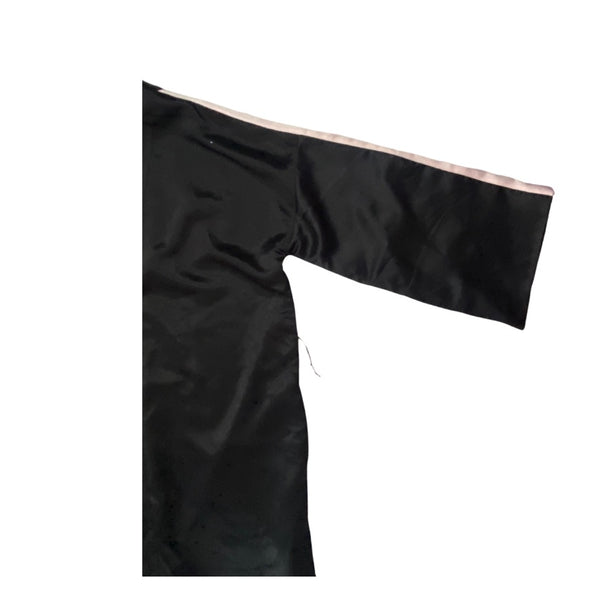 Black satin fabric with a pink border on a white background