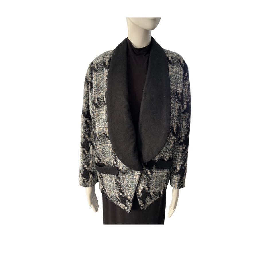 Mannequin wearing a patterned jacket with a black scarf on a white background