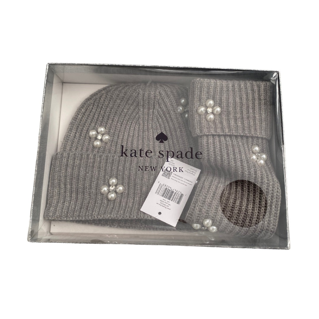 Gray knit beanie with pearl embellishments in a Kate Spade box on a white background