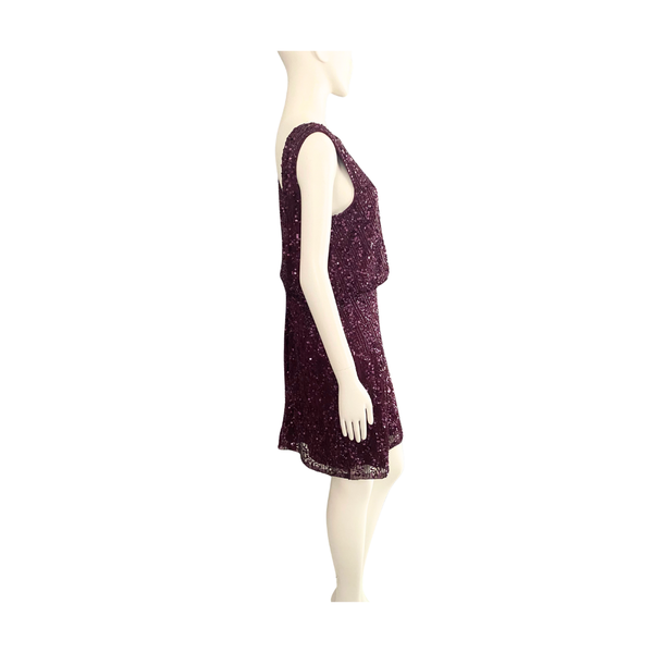 Mannequin wearing a burgundy dress with a subtle pattern on a white background