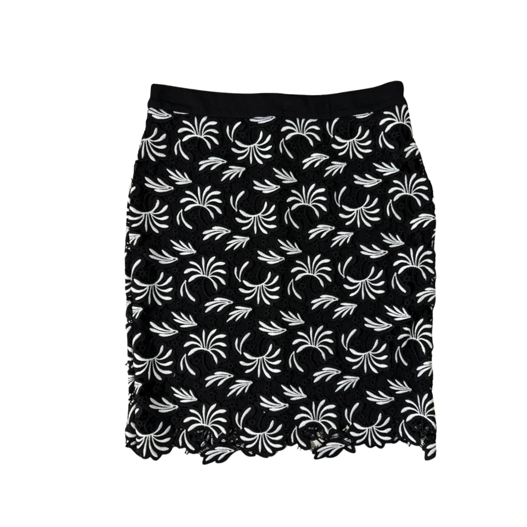 Black skirt with white floral pattern on a white background
