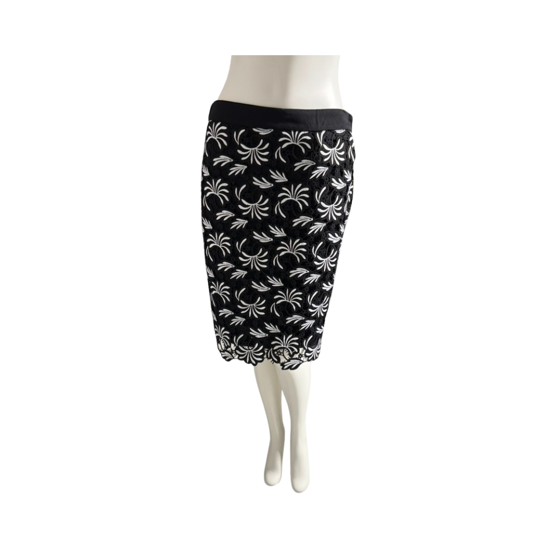 Black pencil skirt with white floral pattern on a mannequin against a white background