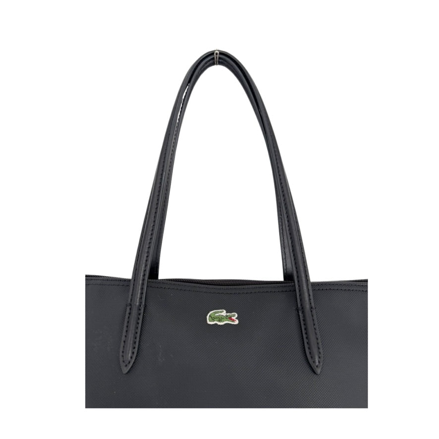 Black handbag with a green logo on a white background