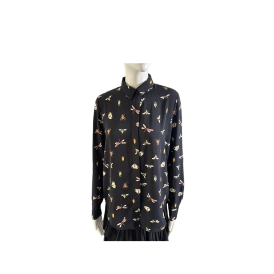 Black shirt with colorful pattern on a mannequin against a white background